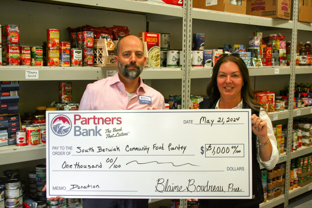 Eric Walker (left), Partners Bank Market Manager at the York Office, proudly presents the $1,000 donation on behalf of Partners Bank to the Program Director of The South Berwick Community Food Pantry, Tanya Cattabriga (right).
