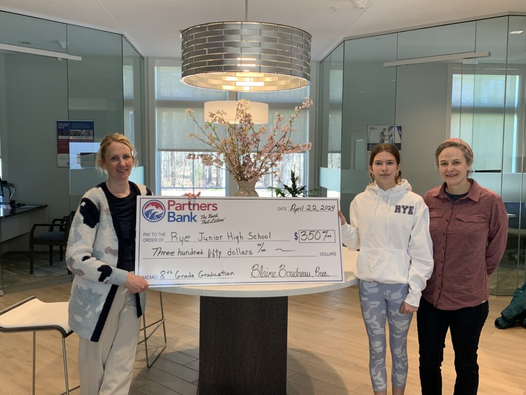 Rye Jr.High students stand in Partners Bank Rye, NH branch for check presentation.