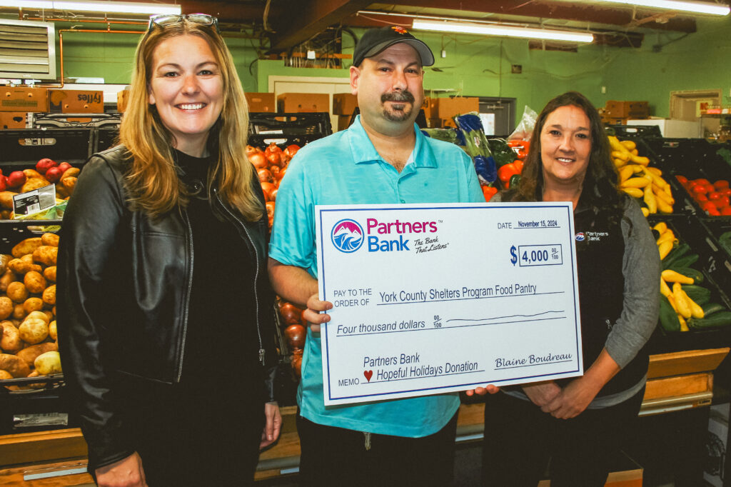 Partners Bank team members donating a check to a local food pantry.